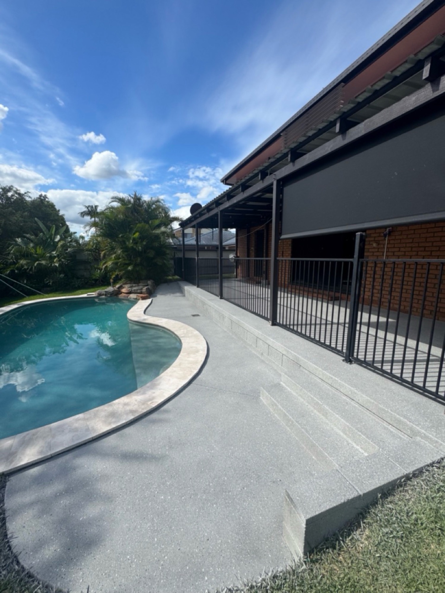 Pool area after covercrete resurfacing - Greystone colour with black and white fleck finish